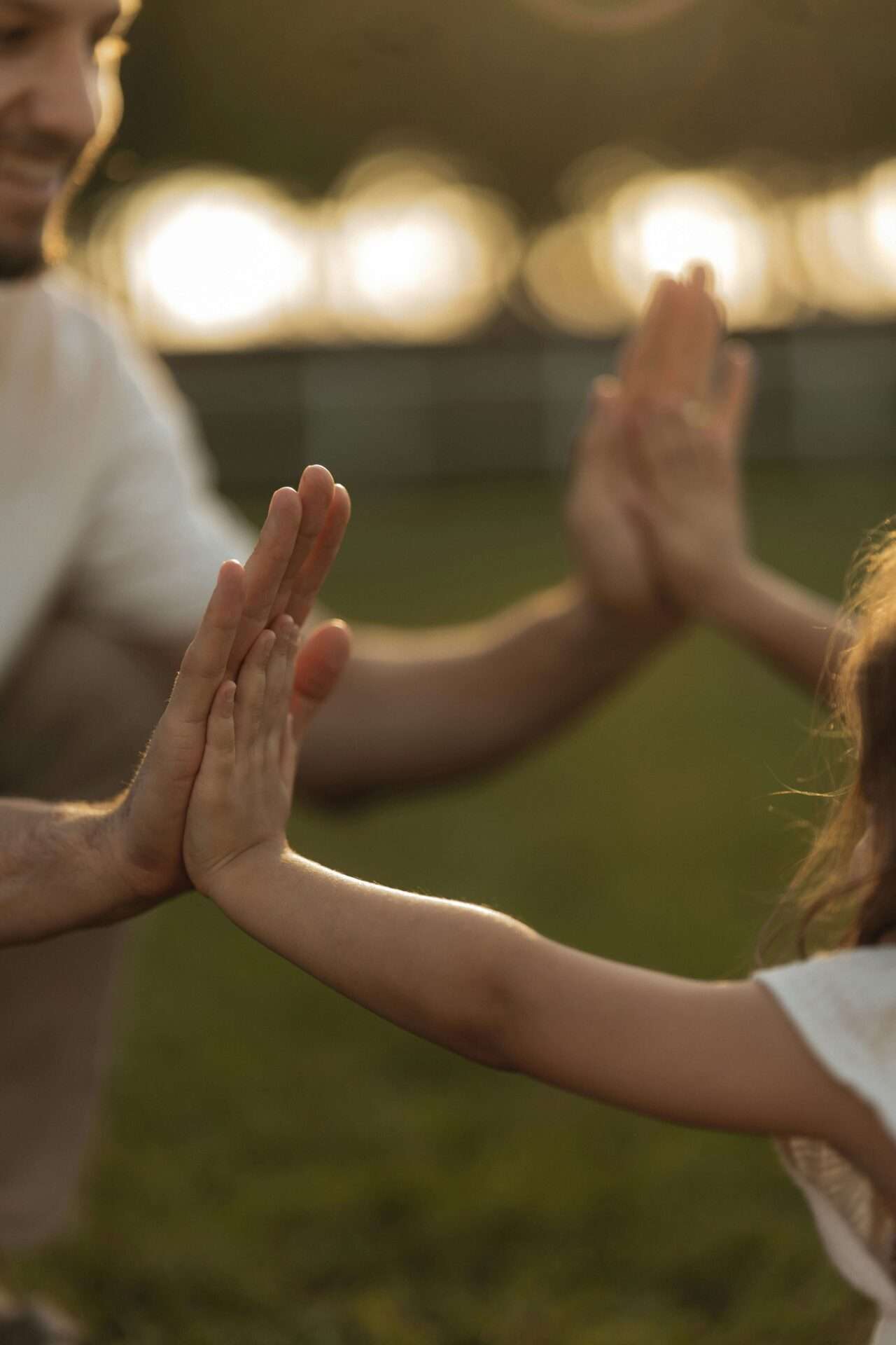 Daughter and dad high fiving